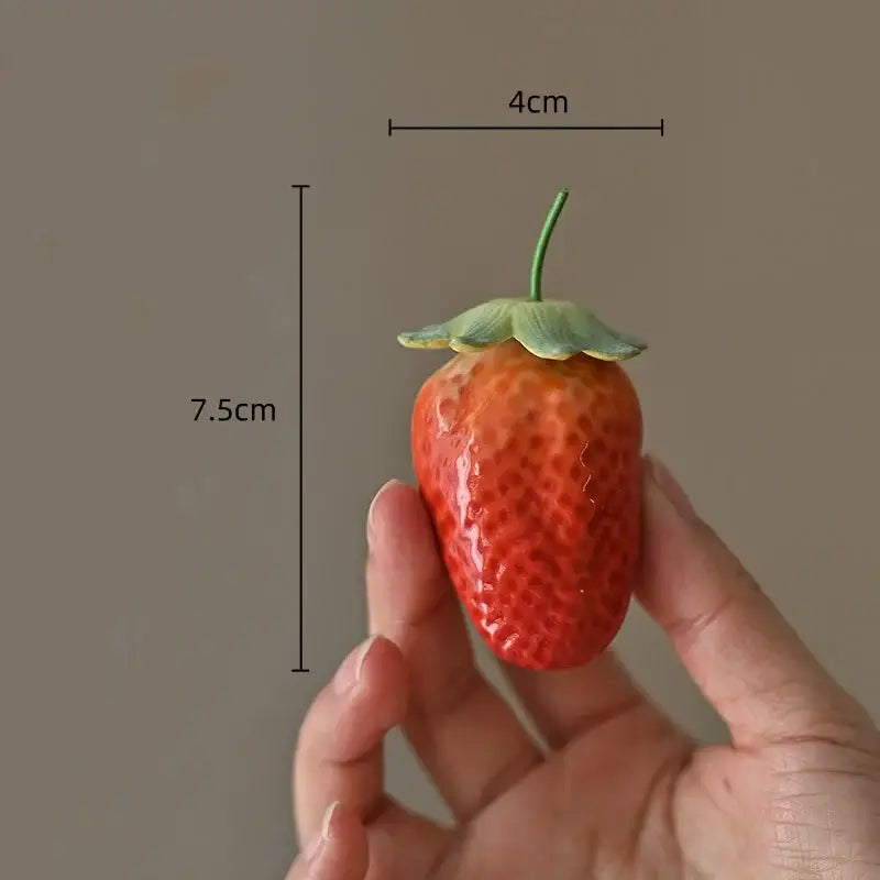 Glossy red ceramic fruit sculpture tea caddy shaped like a strawberry with green stem and leaf for kitchen decor