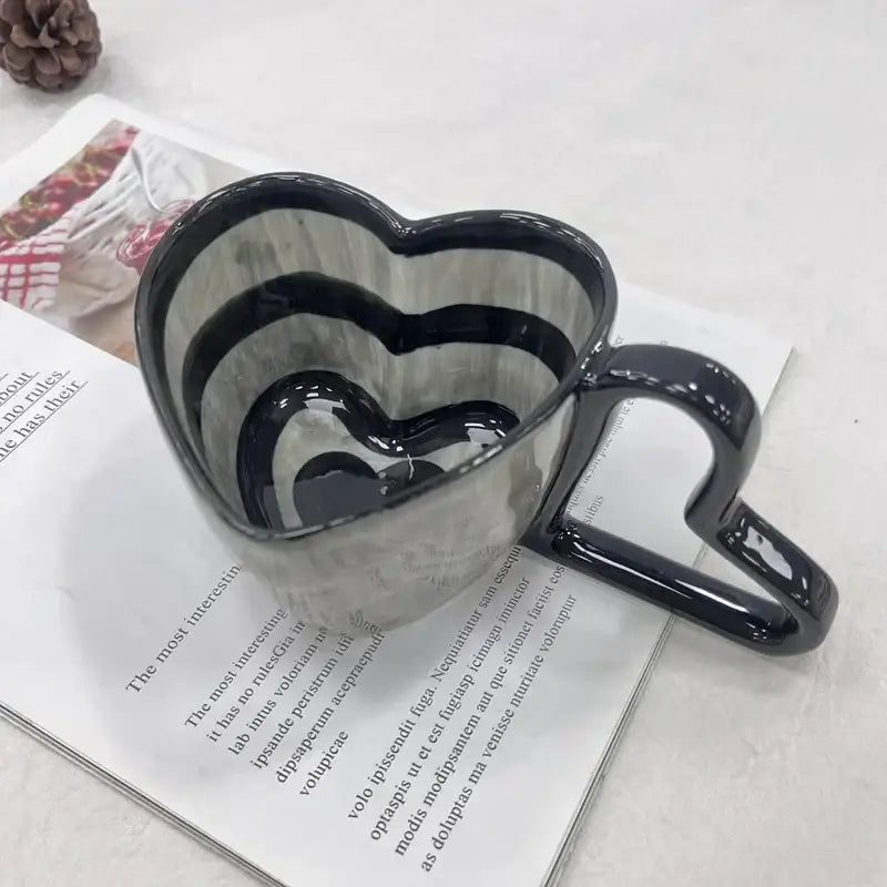 Glossy black heart shape ceramic coffee mug with concentric stripes inside from decorbites heart shape collection
