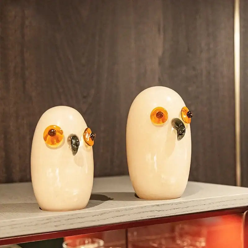 Glossy white cartoon owl glass sculpture with cream color, amber eyes, and black beak for home decor decorbites cartoon owl