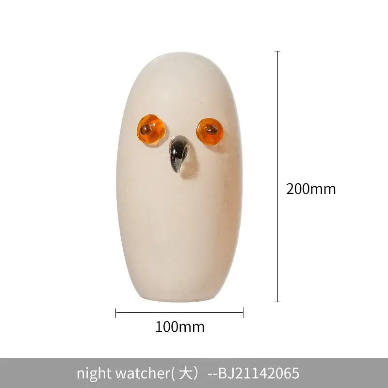 Cream-colored glass cartoon owl sculpture with amber eyes and black beak for living room home decor by decorbites
