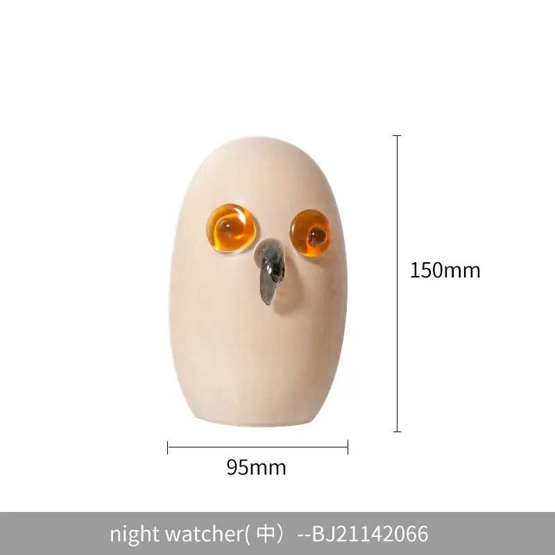 Glossy white cartoon owl glass sculpture home decor with cream-colored body amber eyes and metallic beak by decorbites cartoon owl