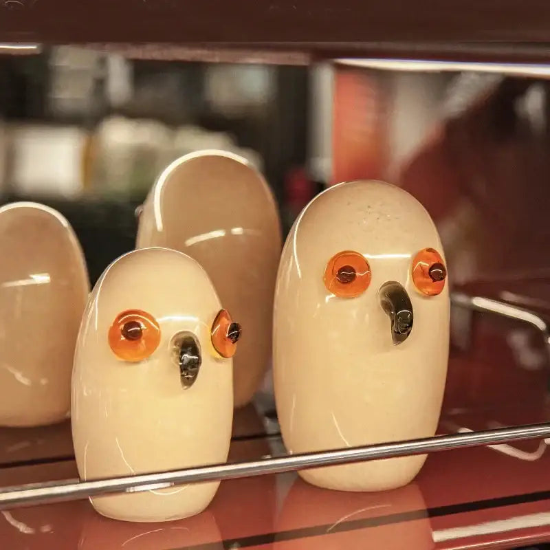 Glossy white cartoon owl glass sculpture with cream ceramic body, glossy orange eyes, and dark beak for home decor by decorbites cartoon owl
