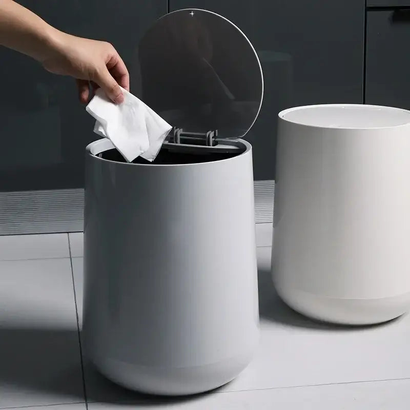 A sleek matte gray cylindrical waste bin with a reflective lid for garbage classification in decorbites kitchen bathroom