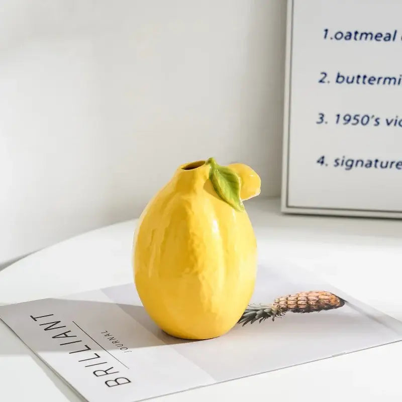 Glossy yellow ceramic lemon flower vase with green leaf accent by decorbites for kitchen citrus decor