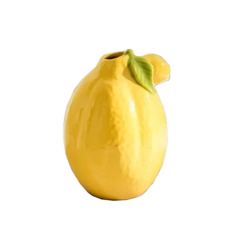 Glossy yellow ceramic lemon flower vase with green leaf accent for kitchen citrus decor by decorbites lemon