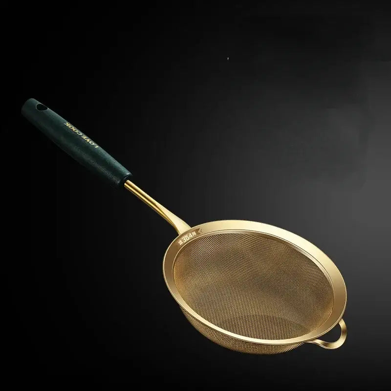 Gold-colored metal kitchen colander juice strainer with dark green handle and small side loop by decorbites kitchen colander