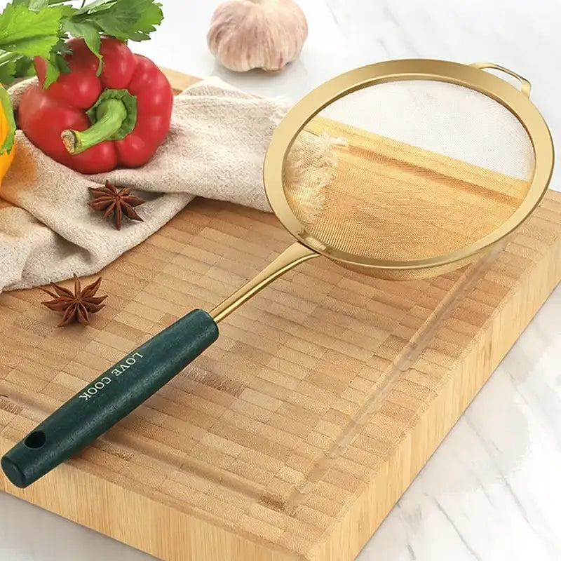 Gold and dark green metal kitchen colander juice strainer with love cook engraving on wooden cutting board decorbites kitchen colander