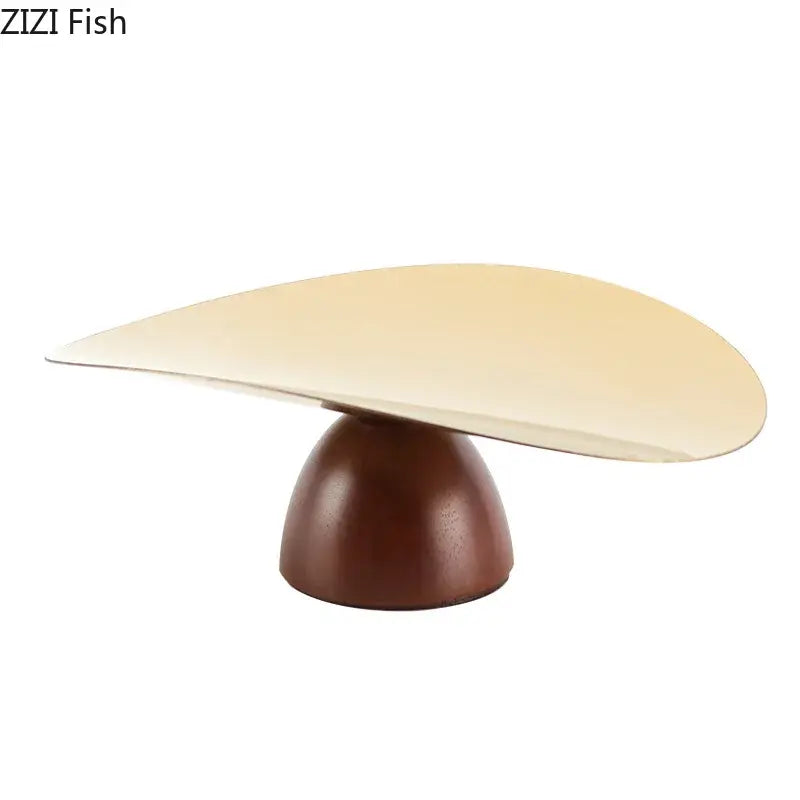 Cream-colored sleekly curved dessert stand with polished wooden base in gold and dark wood fruit bowl tray set