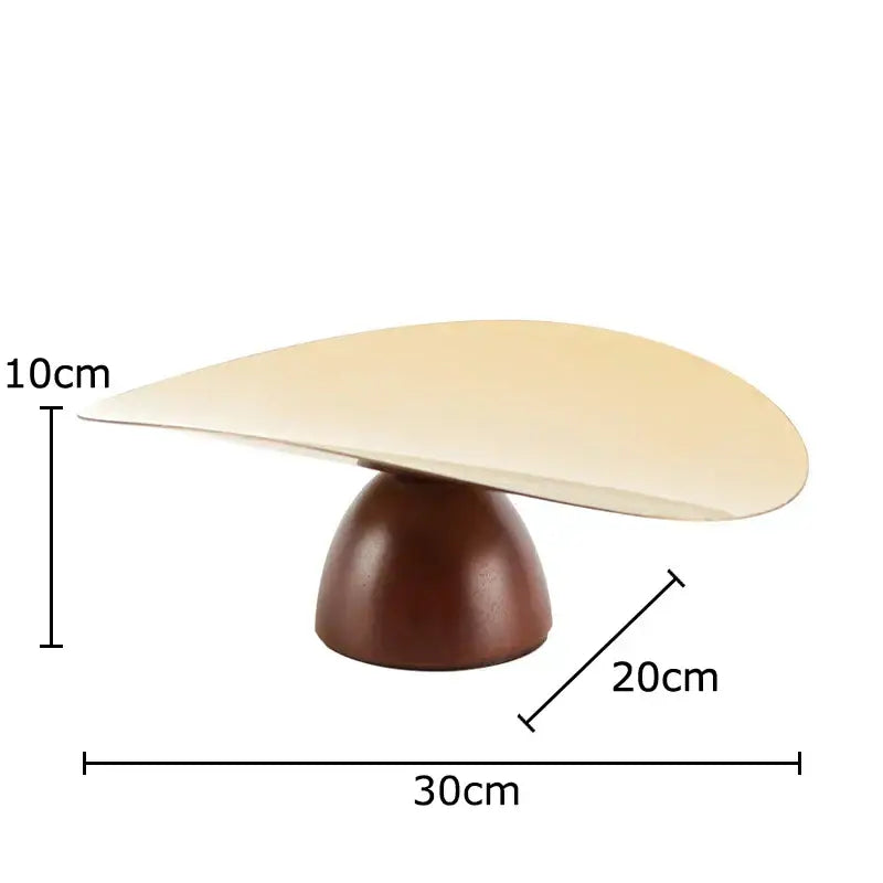 Cream-colored sleekly curved tabletop with polished wooden base in gold and dark wood fruit bowl tray set for kitchen