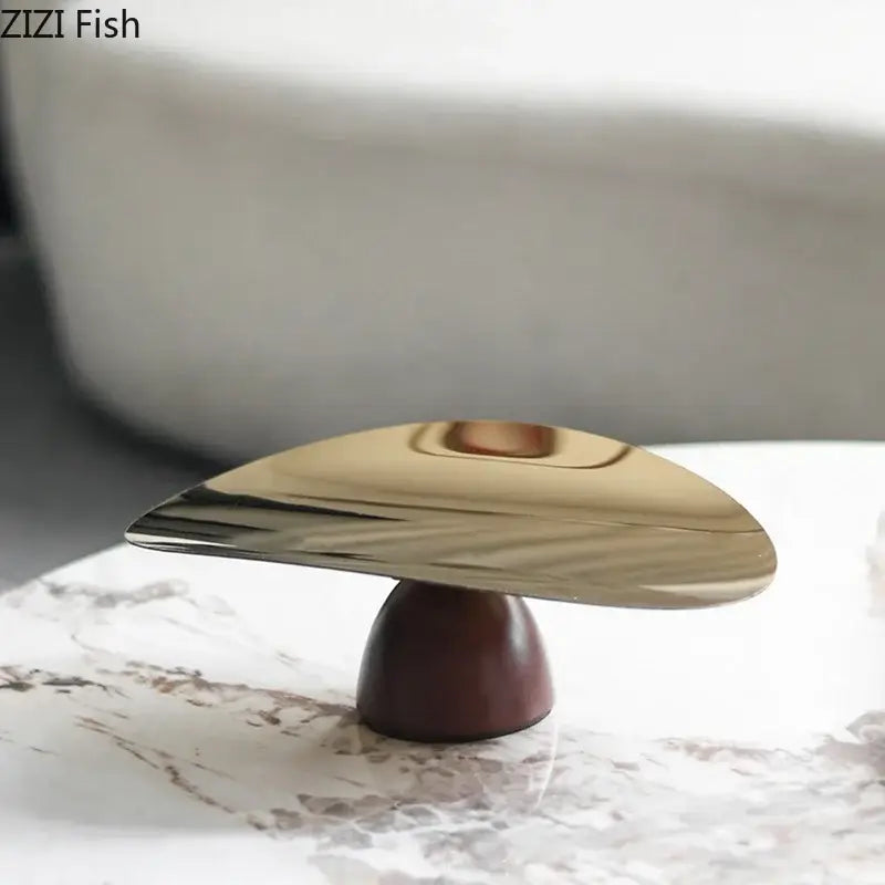Gold-toned sleek metallic bowl tray set with polished finish on dark wood base for kitchen fruit bowl tray use