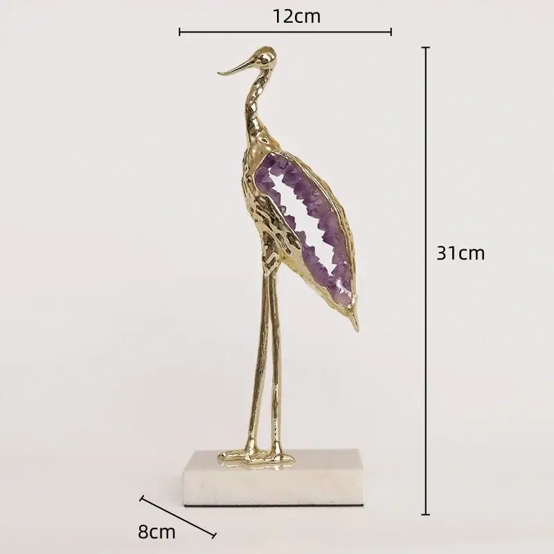 Elegant gold and emerald crystal crane sculpture with purple amethyst geode wing on white marble base for living room decor