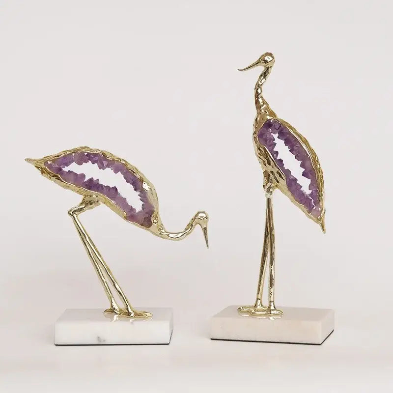 Golden crystal crane sculpture with purple amethyst geode inlays on white marble base for living room decor