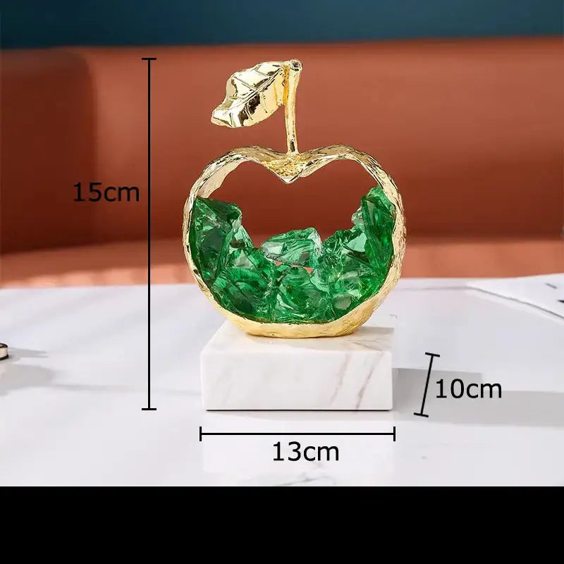 Gold and green crystal apple pear alloy ornament with hollow center and leaf on white marble base for living room decor