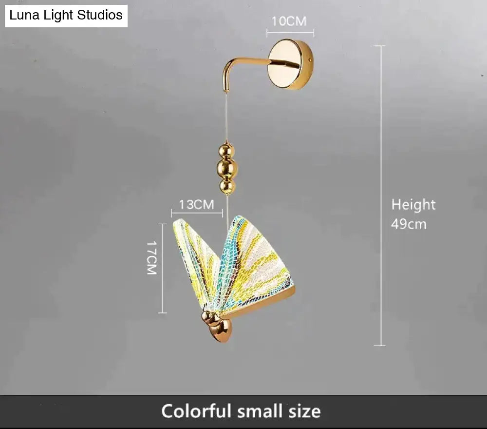 Gold and patterned butterfly led wall light with gold finish and colorful yellow and teal wings for bedroom decor