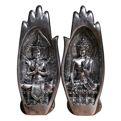 Silver-toned buddha hands monk figurine seated in meditative pose within ornate embossed hand-shaped frame decorbites decor