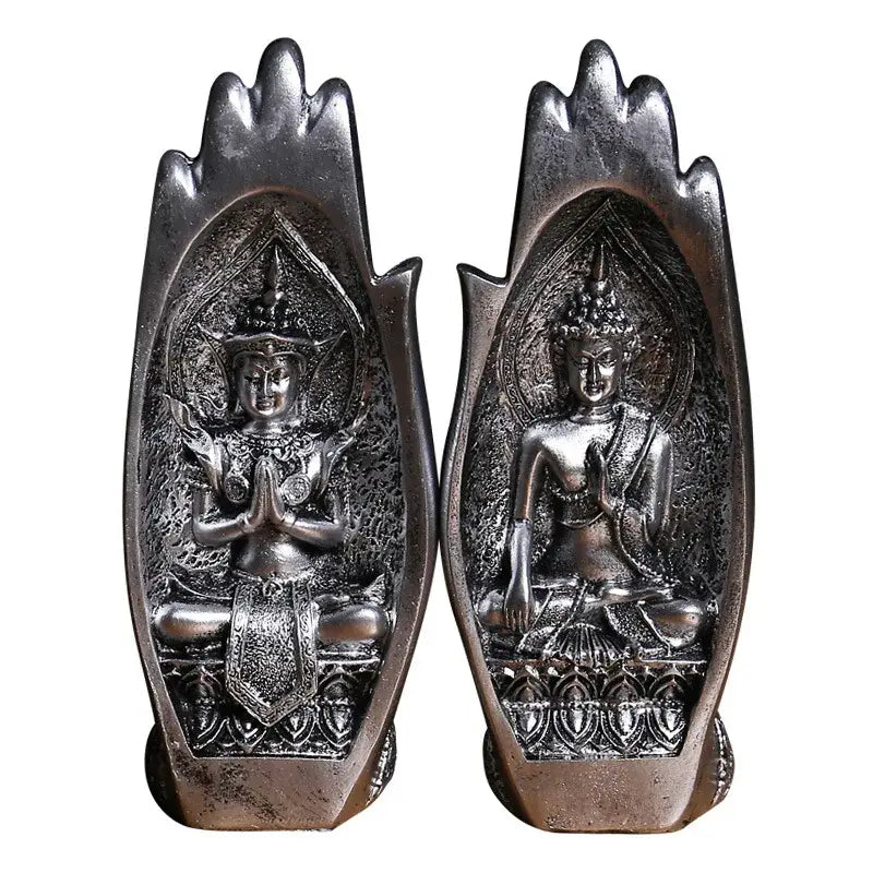 Silver-toned buddha hands monk figurine seated in meditative pose within ornate embossed hand-shaped frame decorbites decor