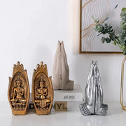 Two golden buddha statues with intricate detailing sit beside a silver resin buddha hands monk figurine decorbites living room decor