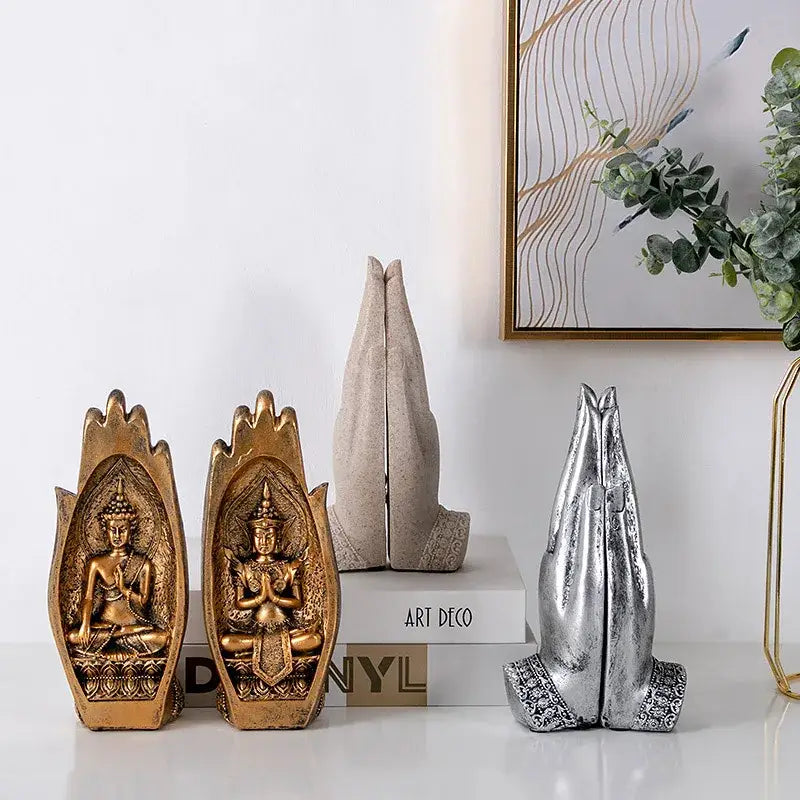 Two golden buddha statues with intricate detailing sit beside a silver resin buddha hands monk figurine decorbites living room decor