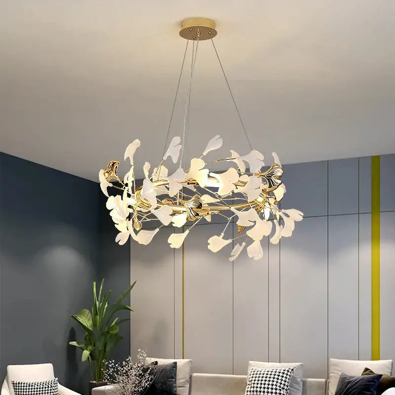 Gold and white ginkgo ceramic chandelier with gold-toned frame and leaf-shaped pieces for dining room decorbites ginkgo ceramic