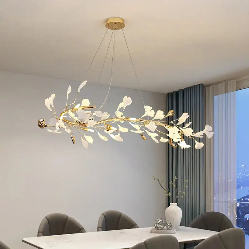 A modern gold and white ginkgo ceramic chandelier with delicate leaf-shaped lights for dining room decorbites ginkgo ceramic