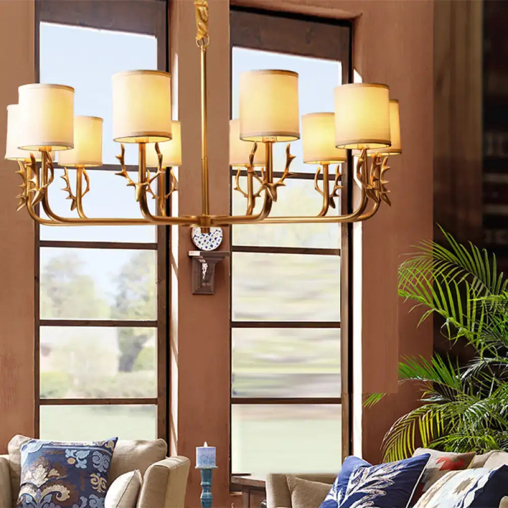 Gold antler fabric shade cylindrical chandelier with cream fabric shades and gold-toned antler deco arms for living room lighting