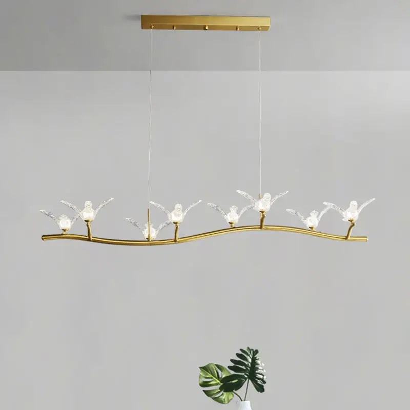 Gold bird branch LED pendant lamp with gold-toned curved branch and six crystal bird figures, adjustable chain cord length