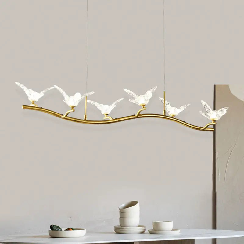 Gold bird branch led pendant lamp with gold-toned metal, five illuminated white bird figures, adjustable chain cord length