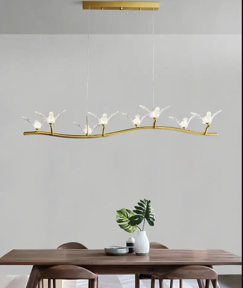 Gold-toned bird branch led pendant lamp with clear glass bird-shaped lamps and adjustable chain cord length for dining room