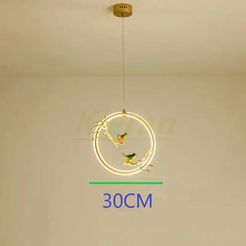 Gold bird led chandelier with a gold-toned metal frame and two glowing birds on branches for dining room decorbites bird led