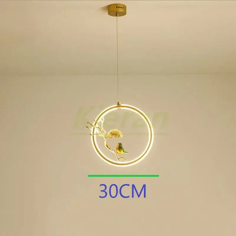 A gold bird led chandelier with a circular led light and metal frame featuring an intricate bird ornament for dining room decorbites bird led