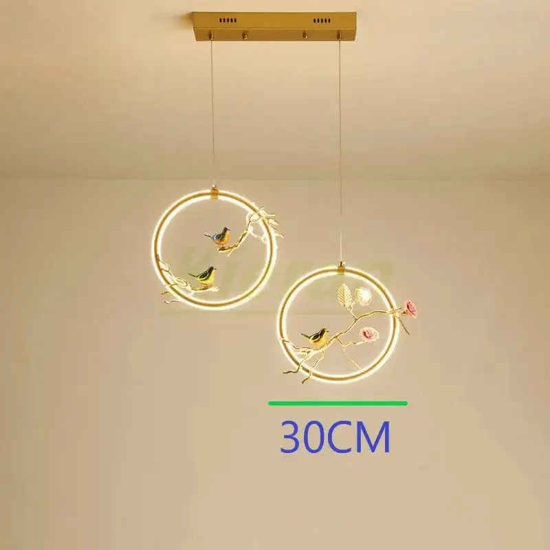 Gold bird led chandelier floral pendant light with gold-toned birds and blossoms illuminated by soft led rings by decorbites bird led