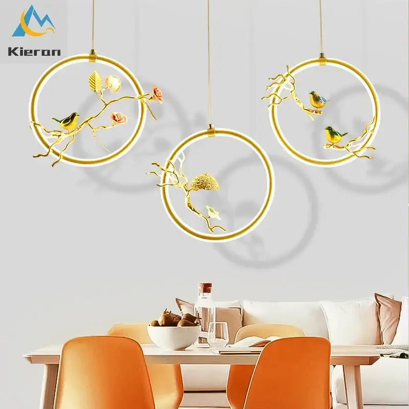 Gold bird led chandelier featuring gold-toned circular pendant lights with intricate bird and floral decorbites bird design