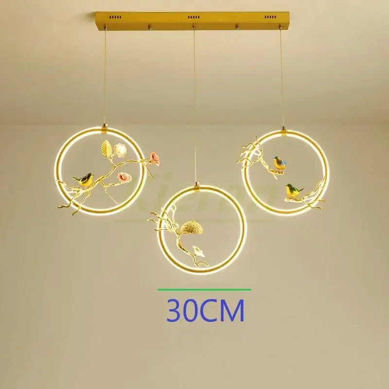 Gold-toned circular decorbites bird led chandelier with intricate bird and floral designs for dining room decor
