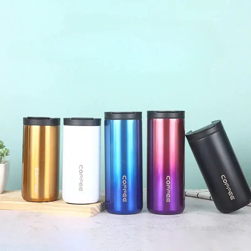 Five decorbites insulated espresso travel mugs in metallic gold, black, white, and gradient colors with vertical coffee print