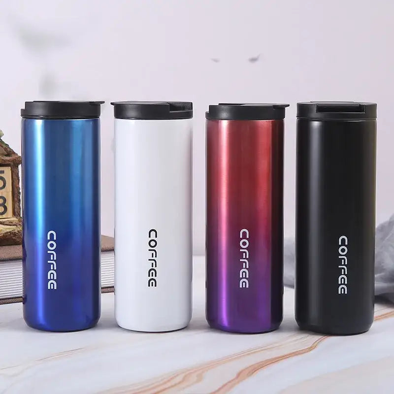 Four sleek stainless steel decorbites insulated espresso cups in blue white gradient and black with black lids for travel
