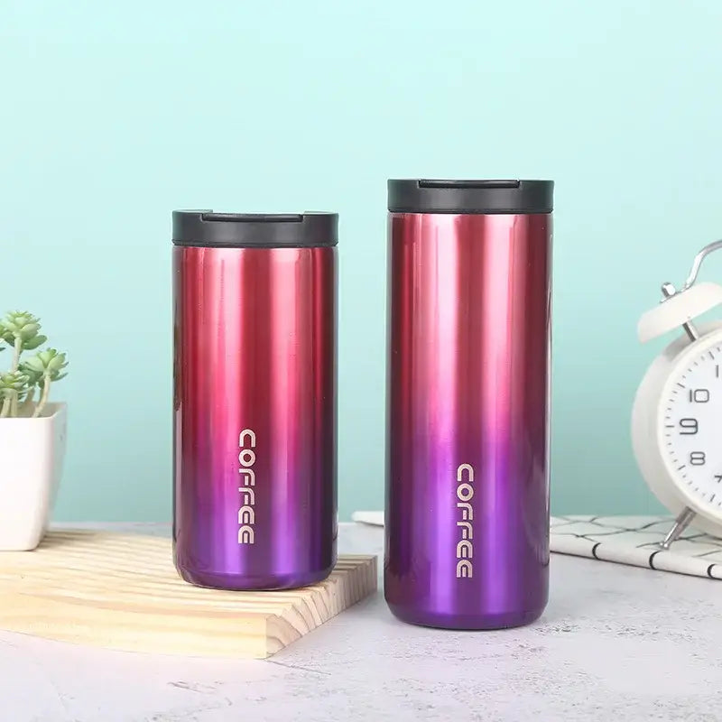 Two decorbites insulated espresso travel mugs with red to purple gradient stainless steel and black lids