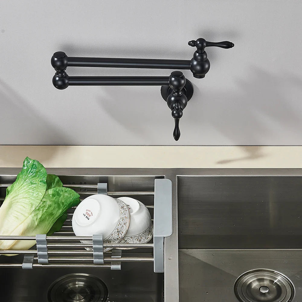 Black matte wall-mounted kitchen faucet with ornate vintage design featured as gold brass pot filler