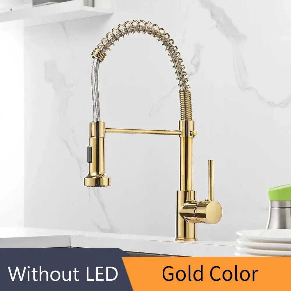 Gold brass spring spout kitchen faucet with pull down spray head featuring a flexible coiled hose and sleek brass finish