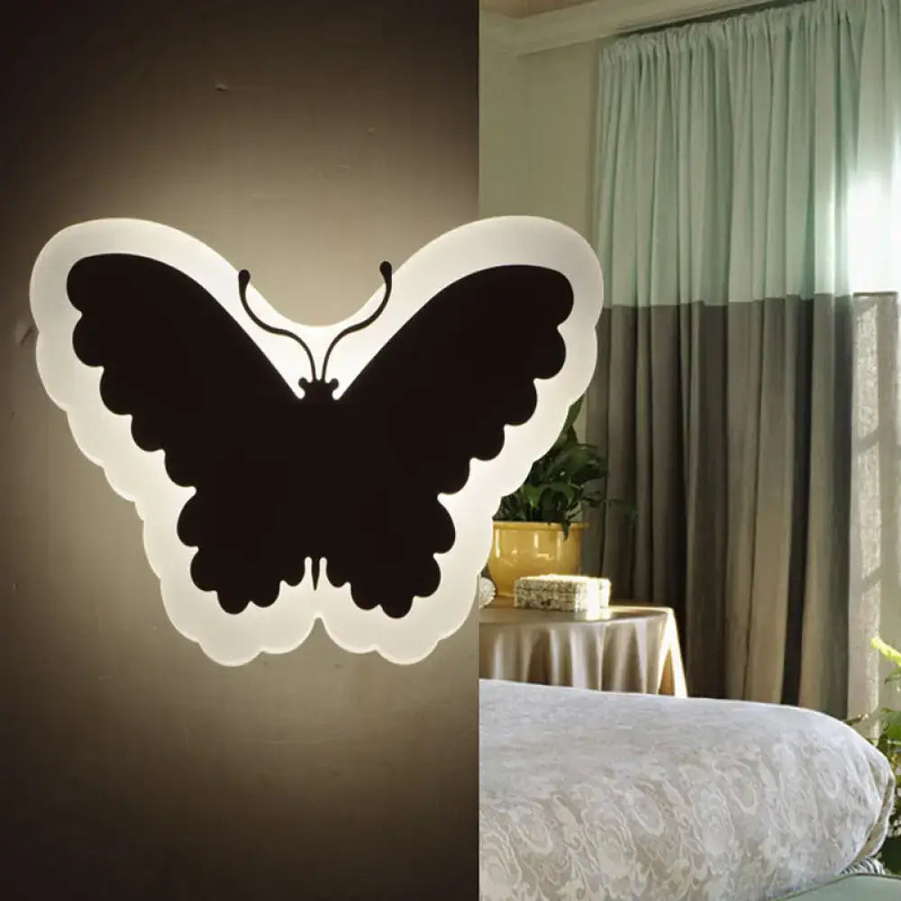 Black butterfly-shaped wall light with glowing white outline for children’s bedroom wall lights and decor