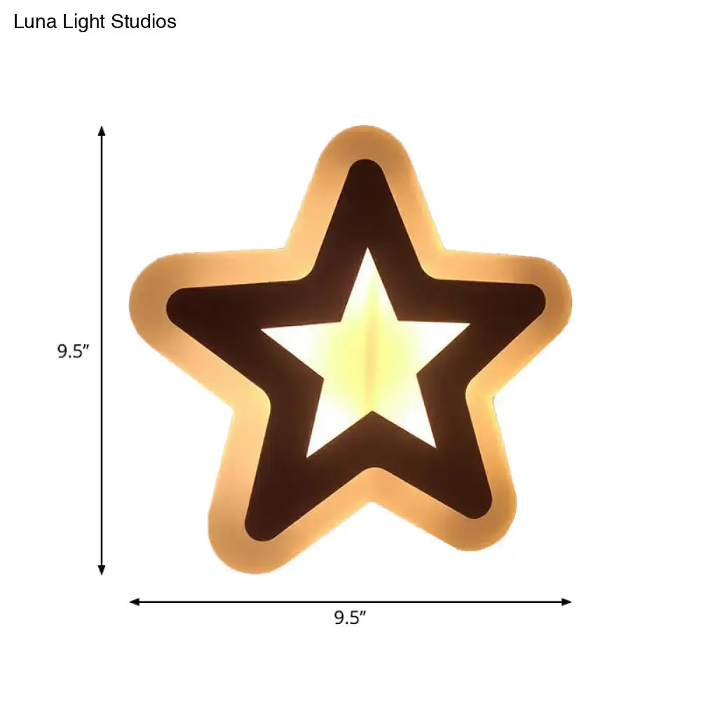 A warm glowing star-shaped wall light with golden frame and dark brown outline for children’s bedroom wall lights
