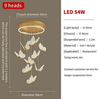 Gold-toned decorbites butterfly chandelier with nine white butterfly ornaments on circular iron and acrylic frame