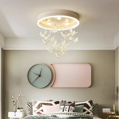 Gold butterfly crystal led ceiling chandelier with white frame and clear bird-shaped pendants for kids bedroom decorbites crystal led