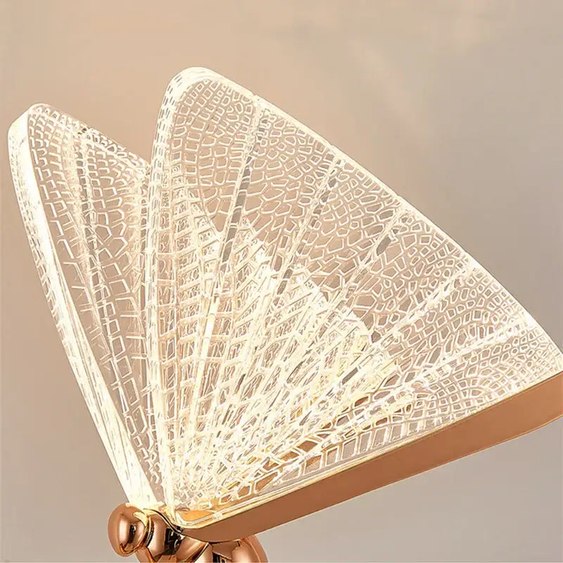 A butterfly led floor lamp with a rose gold metallic base and translucent acrylic lace shade for modern decorbites decor