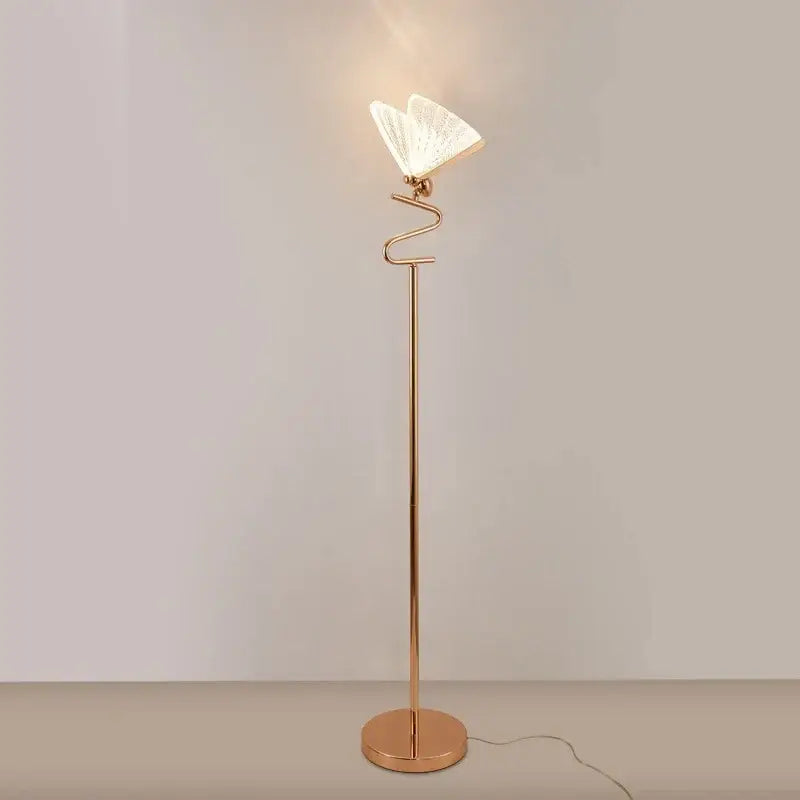 A rose gold decorbites butterfly led floor lamp with a curved stem and illuminated white lace butterfly shade for living room