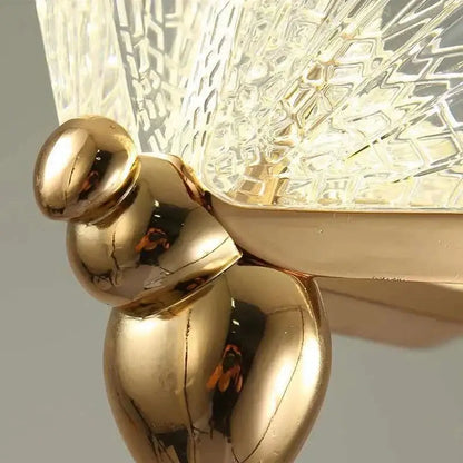 Gold butterfly pendant light with a polished golden metallic lamp base and acrylic elements works beautifully in bedrooms