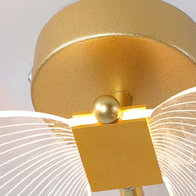 Gold butterfly wall lamp with gold finish square base spherical accent and translucent wing diffusers decorbites butterfly wall