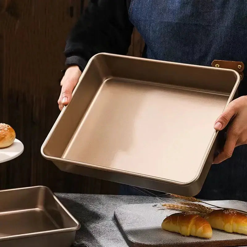 Square gold carbon steel cake baking tray with nonstick surface raised edges and one handle decorbites carbon steel