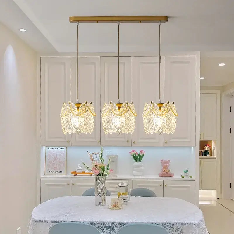 Three elegant gold-toned carved glass pearl pendant lights with intricate crystal lace shades for dining room decorbites chandelier