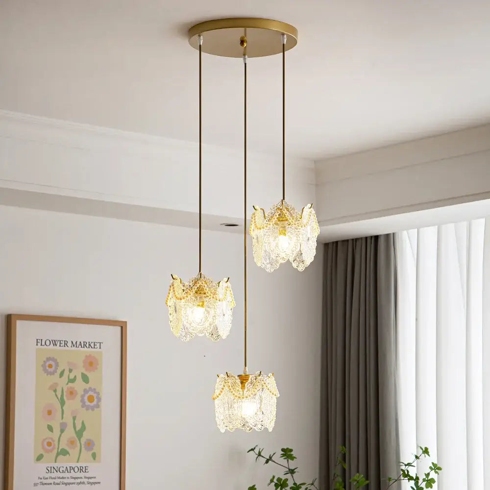 Three-tiered gold carved glass pearl chandelier with crystal floral shades hanging from circular ceiling mount for dining room decorbites carved glass