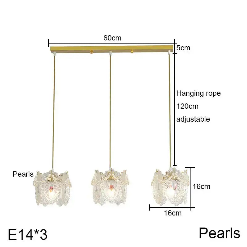 Gold-toned carved glass pearl chandelier with three lace-like glass shades and illuminated e14 bulbs for dining room decorbites